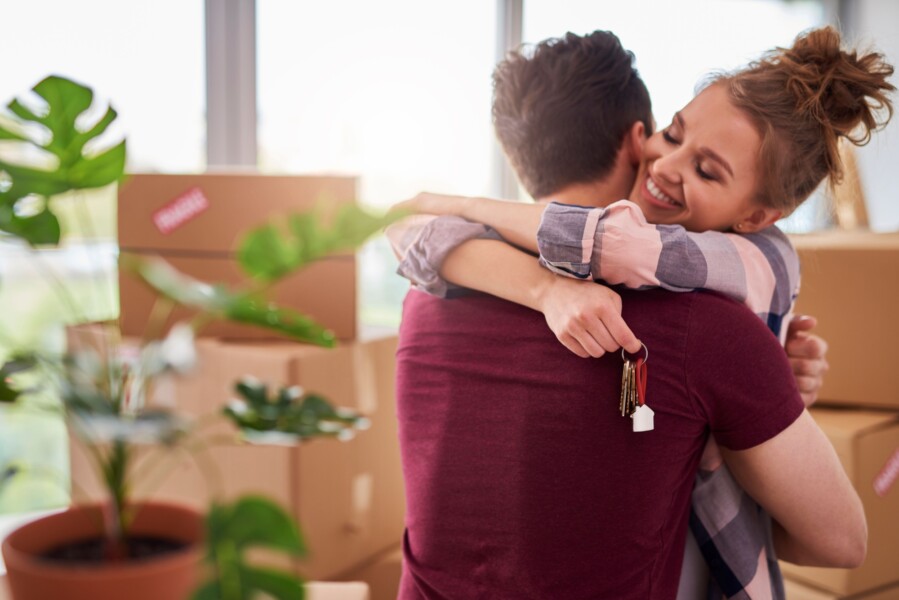 Happy couple with keys new apartment resized