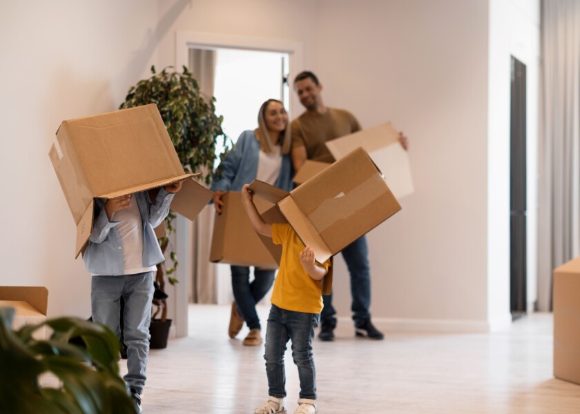 Happy family with kids moving their new home resized